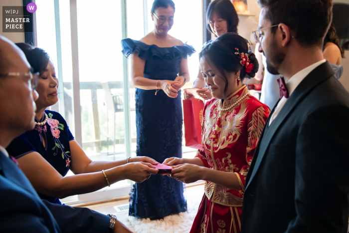 Bride Receives Gift from Mother with Tender Smile, Reflecting Deep Love As the bride receives a gift from her mother with a tender smile, reflecting the deep love and connection they share in this memorable exchange.