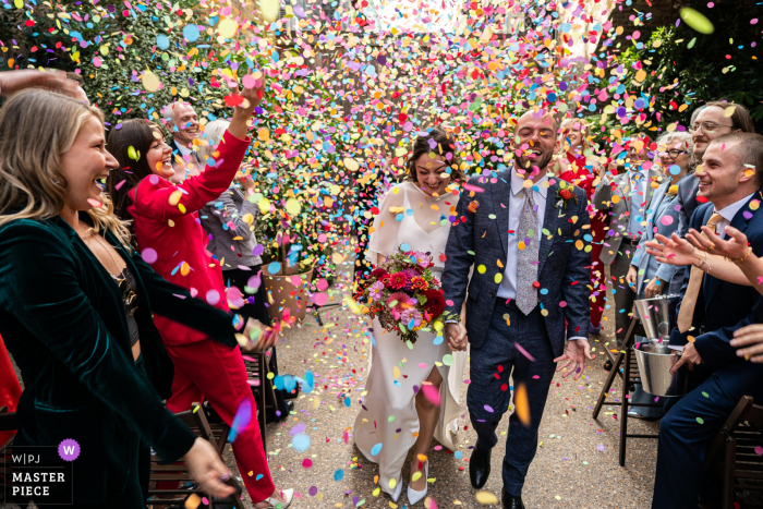 Confetti Fills the Air in a Kaleidoscope of Joy Around Newlyweds in London, UK In London, UK, during the confetti celebration, vibrant colors burst into the air, filling the frame with a kaleidoscope of joy and excitement as they dance around the newlyweds.