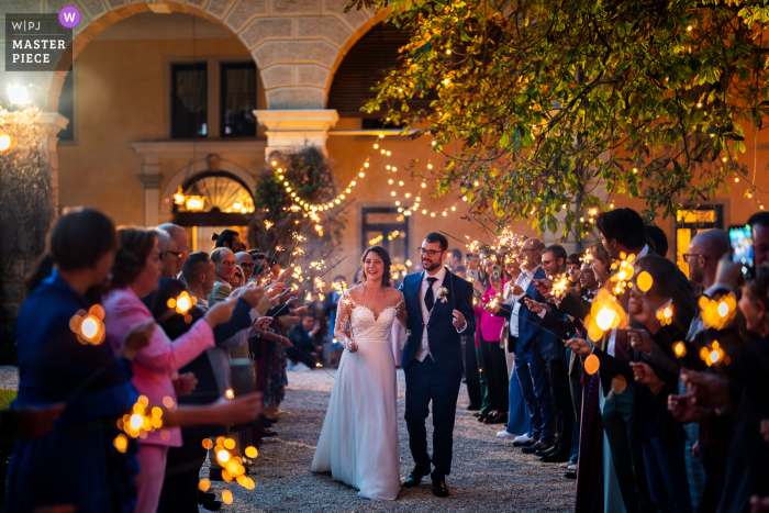 Under the starlit sky at Villa Foscarini Cornaro, Gorgo Al Monticano, the newlyweds gracefully pass through radiant tunnels of sparklers, their faces glowing with happiness and love.