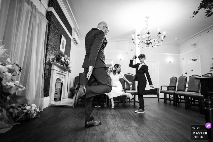 Before exchanging vows, the couple shared a joyful dance to ease any pre-wedding jitters with a young gentleman at Southwark Register Office in London.
