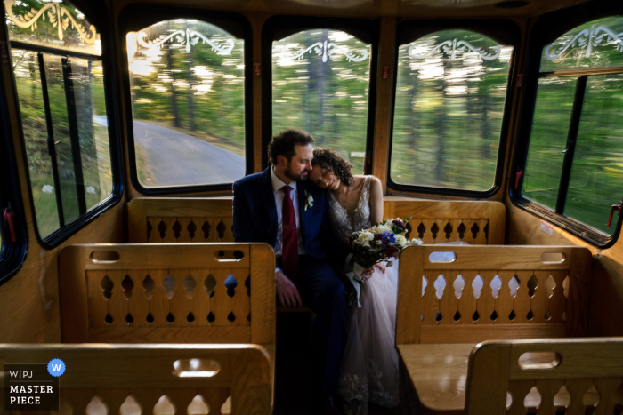 Couple Reflects on Their Special Day Aboard Trolley at Castle in the Clouds As the trolley winds its way through the stunning grounds of the Castle in the Clouds, the couple takes a moment to reflect on their special day.