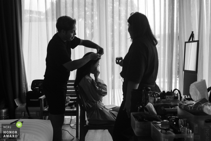 At The Naka Phuket in Thailand, the bride becomes emotional and can't hold back her tears as she practices her wedding vows during bridal preparation, highlighting the significance and heartfelt nature of the upcoming ceremony.