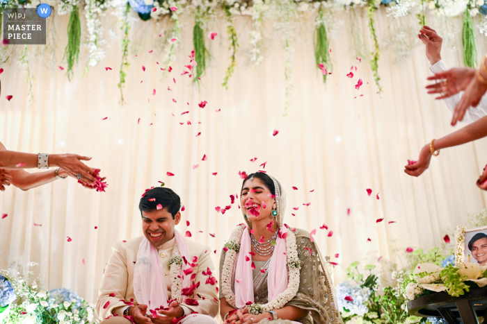 Couple Joyfully Showered with Flower Petals at Taj Mahal Palace, Celebrating Wedding's Conclusion in Mumbai At the Taj Mahal Palace in Mumbai, the couple is joyfully showered with flower petals as their wedding ceremony concludes.ita Asthana, of Maharashtra, is a wedding photographer for