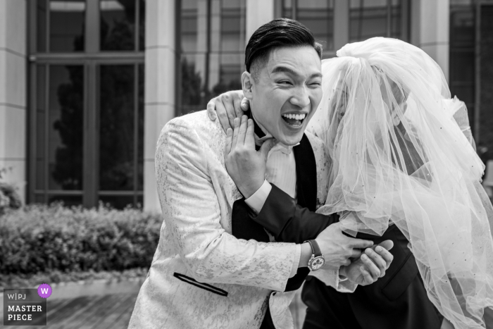 Best Man Dressed as Bride Surprises Groom at Taipei Marriott, Adding Humor to First Look Session At the Taipei Marriott Hotel in Taiwan, the best man playfully dressed up as the bride to surprise the groom during their first look session. This humorous and unexpected twist added laughter and fun to the wedding day festivities.