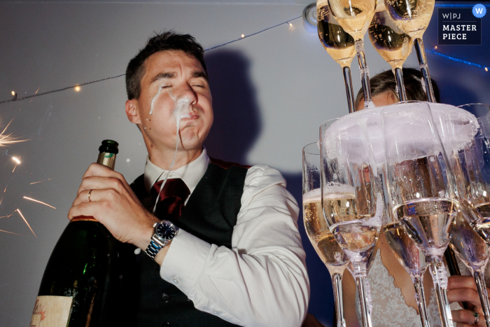 Groom Spills Champagne Taking Swig in Paris, Adding Humor to Wedding Celebration in Paparazzi-Style Flash In Paris, the groom, caught in a paparazzi-style flash, takes a swig of champagne straight from the bottle, spilling some onto himself. This candid moment adds a touch of humor and spontaneity to the celebration.