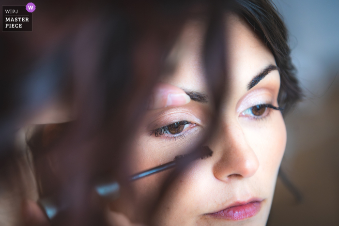 At Chateau de la Pouyade in Angouleme, the bride prepares for her wedding day, surrounded by anticipation and excitement as she gets ready.