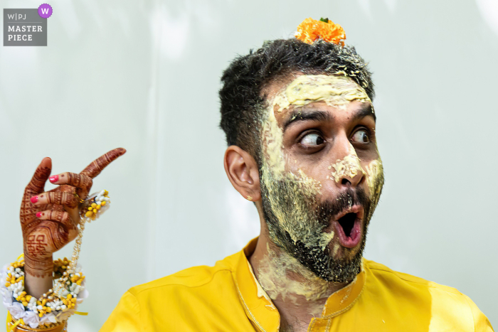 A Flower Lands On The Groom’s Head, Surprising The Couple In The Backyard Of Their Northside Drive, Atlanta Home. In the backyard of a home on Northside Drive in Atlanta, the bride and groom share a surprised reaction when a flower unexpectedly lands on the groom’s head during their celebration.
