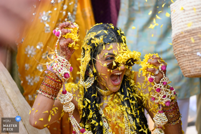   Petals pour down in overwhelming abundance on the bride at the Hilton in Abu Dhabi, making for a dramatic and joyous display unlike any other wedding tradition.