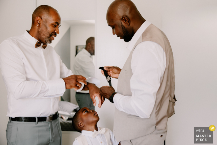   At Sologne in Centre-Val de Loire, fine wedding details are put on groom's wrist and photographed, highlighting the thoughtful touches that contribute to the feeling of the day.