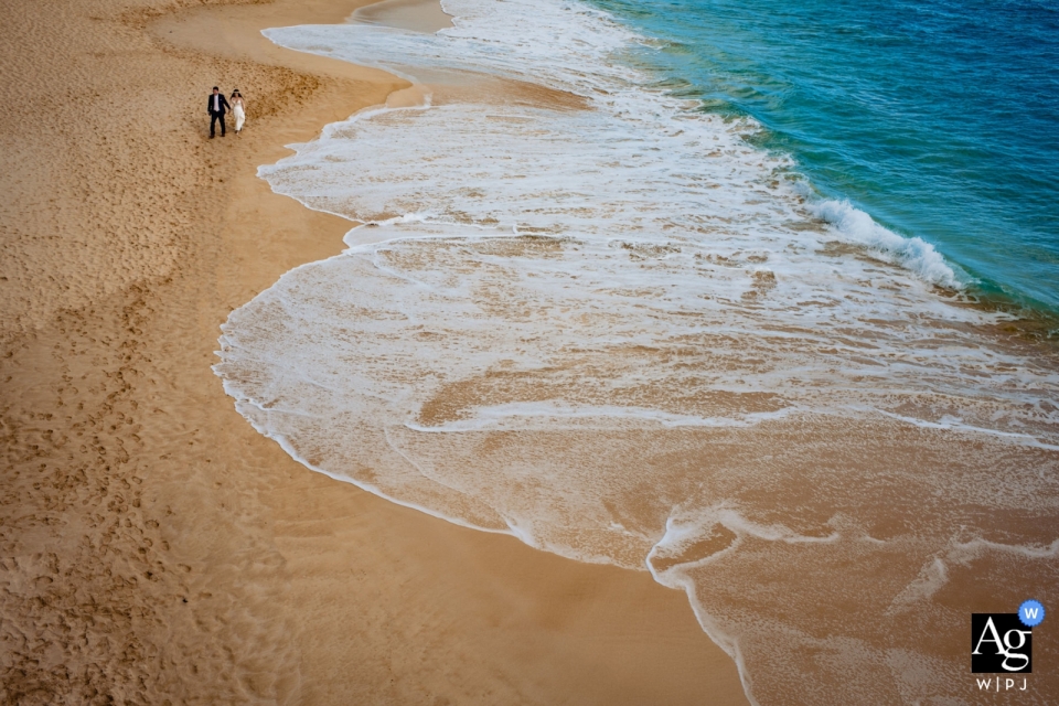 A picture of the bride and groom at Hotel Wailea featured a top-down view of the beach showcasing its diverse colors and textures