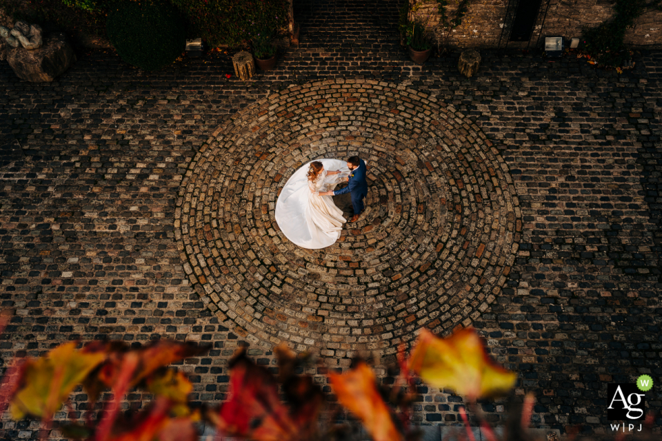 Photo by: <a href="https://www.wpja.com/photos/artistic-wedding-photographers/2615830">Jenny Rutterford - Shoreham-by-Sea West Sussex Walton Castle, Somerset, England wedding couple posed portrait session of the bride and groom dancing in castle courtyard, captured from above