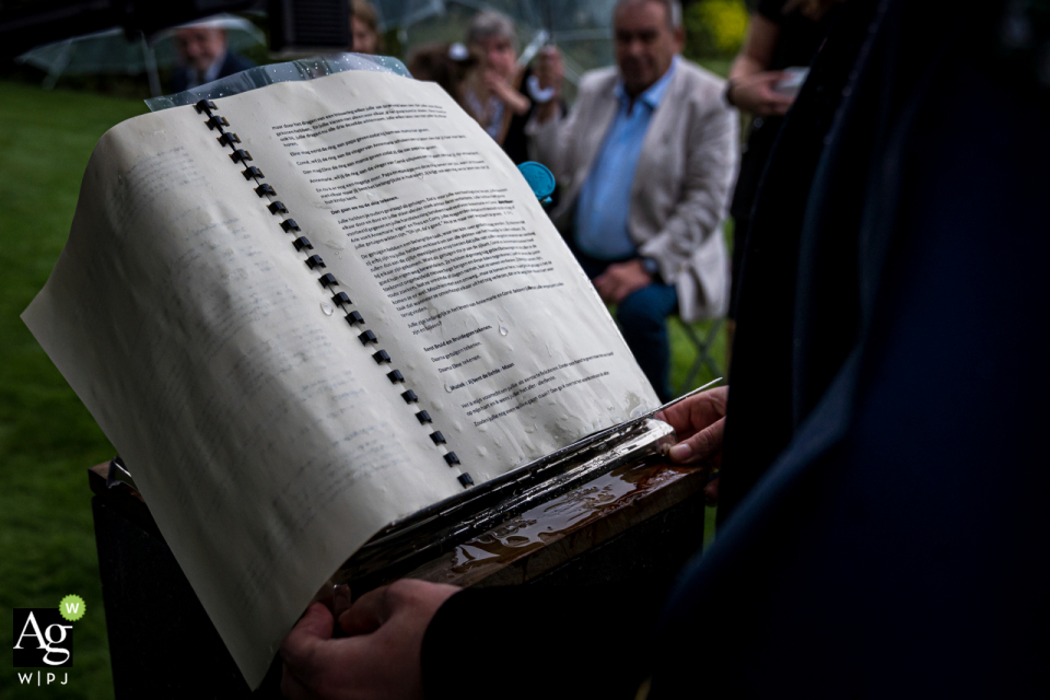 A first rate wedding detail picture from a Hoeven marriage event at Landgoed Tielens in The Netherlands showing The text of the wedding official got completely wet during the ceremony due to the rain A first rate wedding detail picture from a Hoeven marriage event at Landgoed Tielens in The Netherlands showing The text of the wedding official got completely wet during the ceremony due to the rain