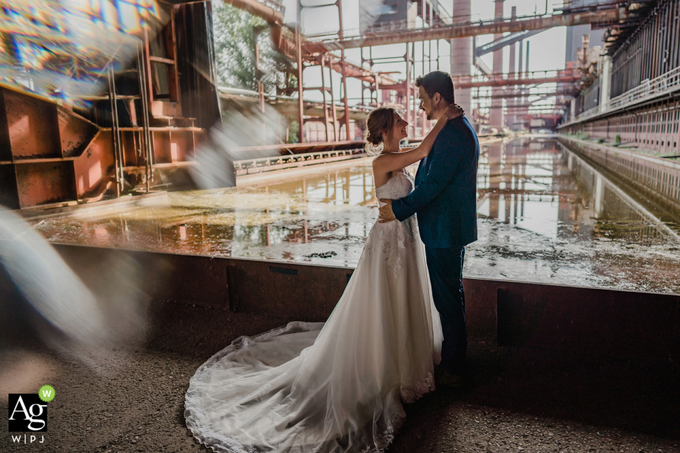 Dramatic Zeche Zollverein wedding image of this Essen bride and groom in Germany showing a couple in front of old industry buildings Dramatic Zeche Zollverein wedding image of this Essen bride and groom in Germany showing a couple in front of old industry buildings