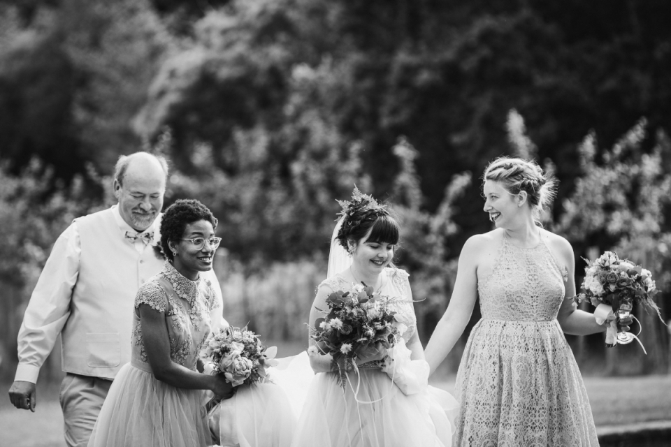 Black Pig Orchard, Chelwood Gate, East Sussex, United Kingdom | Wedding Venue Pictures The bride is walking along with some help at Black Pig Orchard, Chelwood Gate, East Sussex, United Kingdom