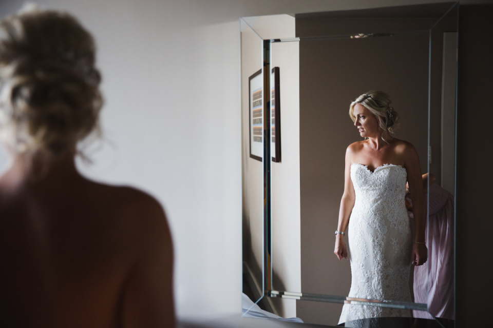 St George's Hill Golf Club, Weybridge, United Kingdom |Wedding venue pictures of the bride Photo of the bride standing before a mirror at the St George's Hill Golf Club, Weybridge, United Kingdom