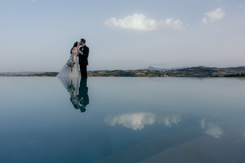 Magnolia Luxury Relais, Longiano, Italy - image of couple kissing Wedding image of a couple in swiming pool reflection of magnolia , longiano, italy