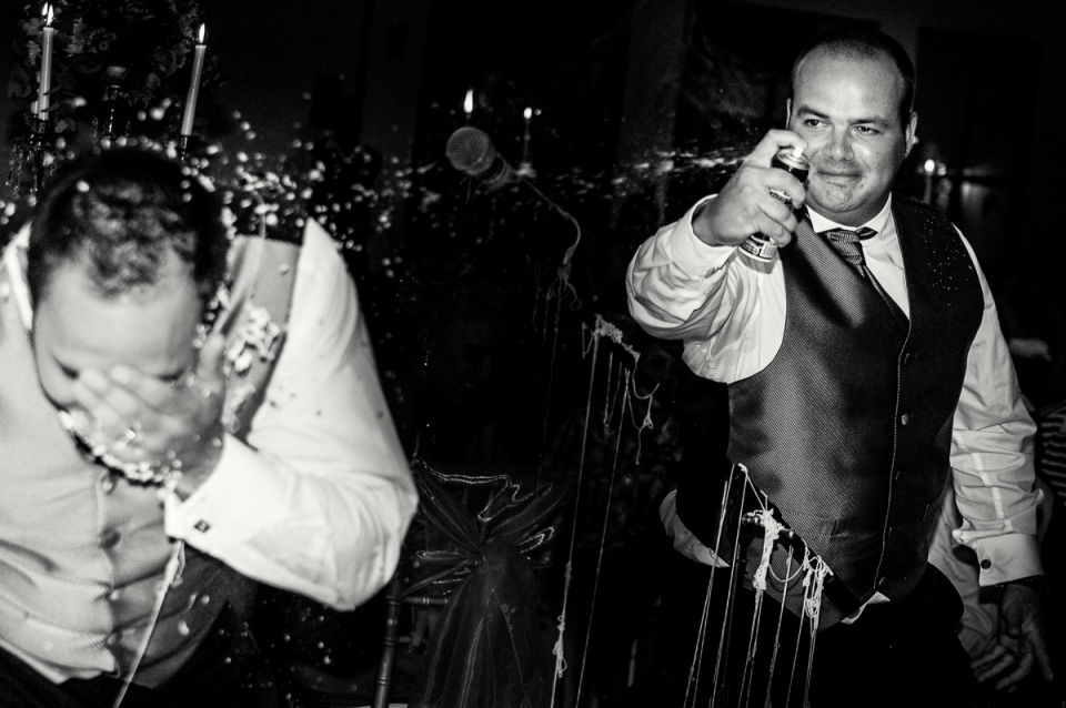 Tramonto, South Africa wedding reception celebration image with silly string to the face Tramonto, South Africa wedding reception celebration image in black and white