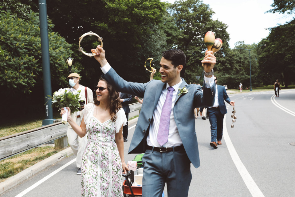 Fun Central Park Wedding Photography of a couple walking in the roadway Central Park Elopement image of the bride and groom walking in the street