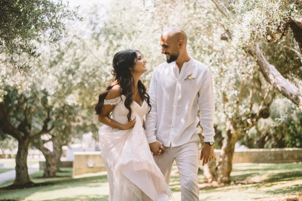 Holy Apostles Catholic Church, Glyfada wedding photo of a couple walking hand in hand happy couple walking hand in hand - Holy Apostles Catholic Church, Glyfada wedding photography