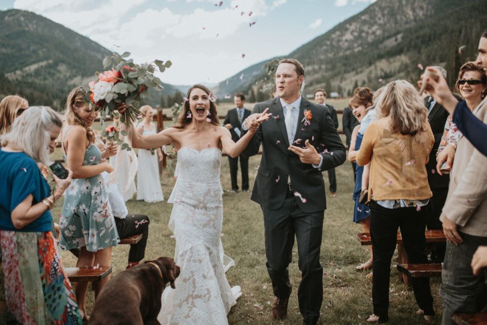 Iowa outdoor wedding ceremony photography. Iowa outdoor wedding ceremony photographer captured the celebration of the bride and groom in this color image.