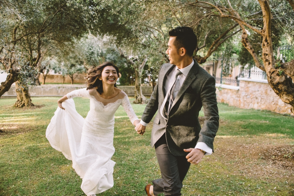 Plaka, Athens, Greece wedding photo of a couple running and smiling Photo of Saint George Lycabettus newlywed wedding couple running smiling