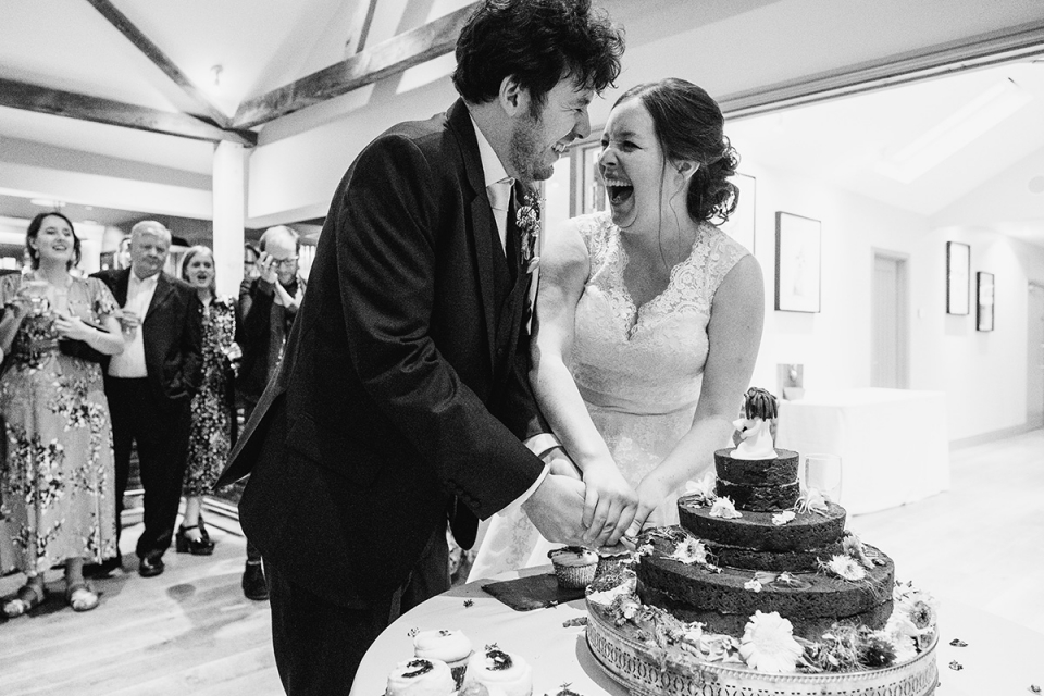 Photo of Couple cutting their wedding cake at Easton Grange, Suffolk Couple cutting their wedding cake at Easton Grange, Suffolk photographed by venue recommended photographer Dominic Whiten