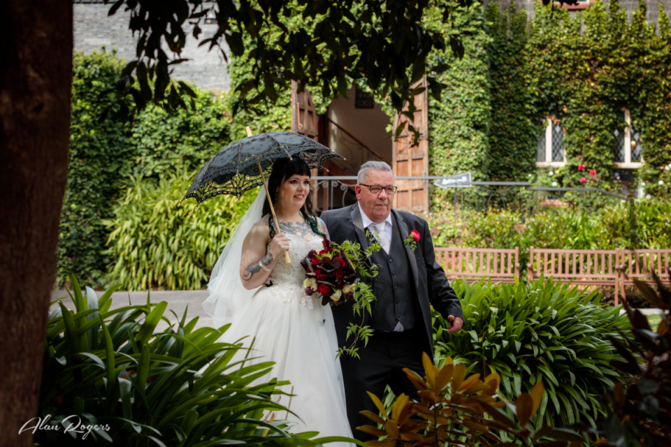Wedding image on a gorgeous sunny day at Avalon Castle as a Father walks his daughter down the aisle Picture showing a nervous Father and Bride at Avalon Castle - Australia