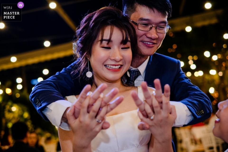 Ho Chi Minh City-huwelijksfotografie met bruid en bruidegomholdingshanden Ho Chi Minh City-de foto van de huwelijksontvangst van bruid en bruidegomholdingshanden op de dansvloer