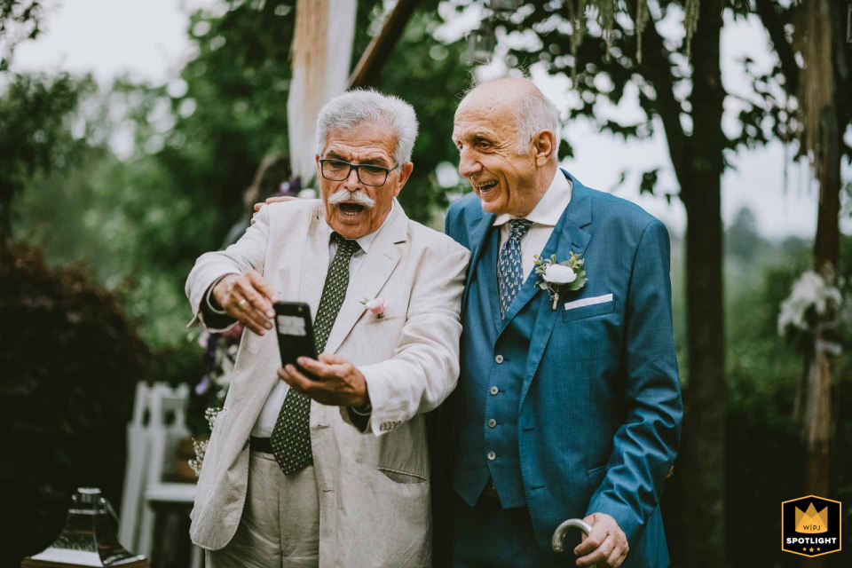 Generational Connection: A Selfie at Adile Sultan Palace At Adile Sultan Palace, two tec-savvy grandfathers share a heartfelt moment as they take a selfie together during the wedding celebration.