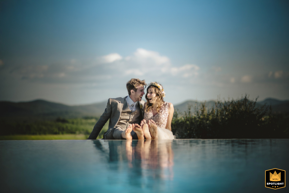A couple poses for a portrait at Tenuta di Papena in Tuscany. The wedding photo captures the pair against the region's landscape.