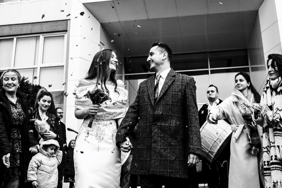 The brides friends waited for her and groom to exit her home, throwing rose petals