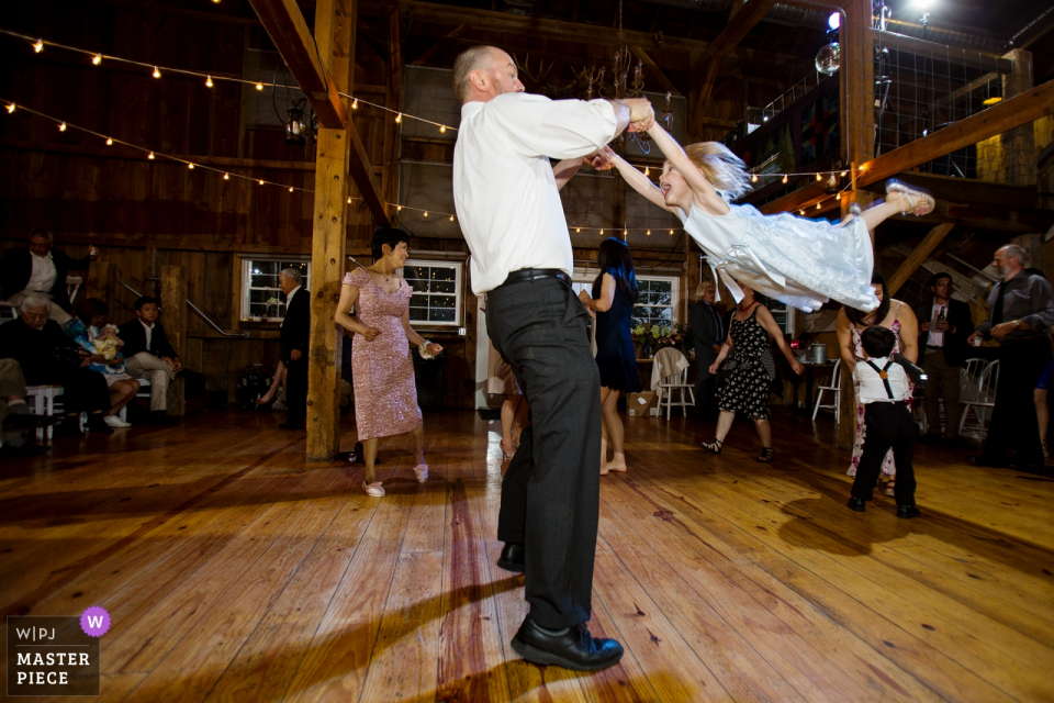 the Groom swings around little girl on the dance floor Groom swings around little girl on the dance floor at The Barn at Harvest Moon Pond, Poynette,