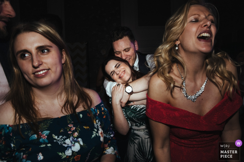 Photo by: <a href="https://www.wpja.com/contests/2018-v07-photography-competition/best-wedding-photographers/2228911">Lyndsey Goddard - London London</a> Bridal party singing and smiling at the wedding reception at The George in Rye, UK