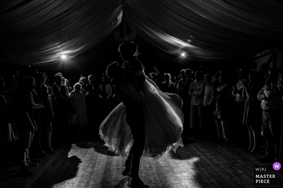 the Groom lifts the bride while dancing Groom lifts the bride while dancing at the wedding reception in Châtreau de Kerambleiz