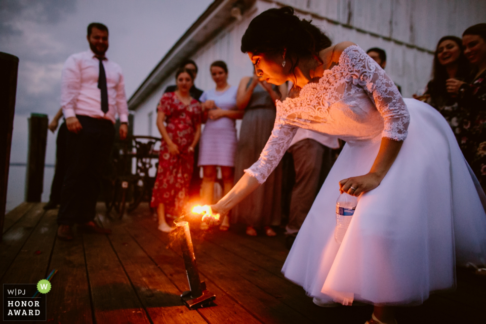 Photo by: <a href="https://www.wpja.com/contests/2018-v10-photography-competition/best-wedding-photographers/2254441">Masao Okano - North Chelmsford Massachusetts</a> Bride lights a candle at her wedding ceremony at Hope House in Easton, MD