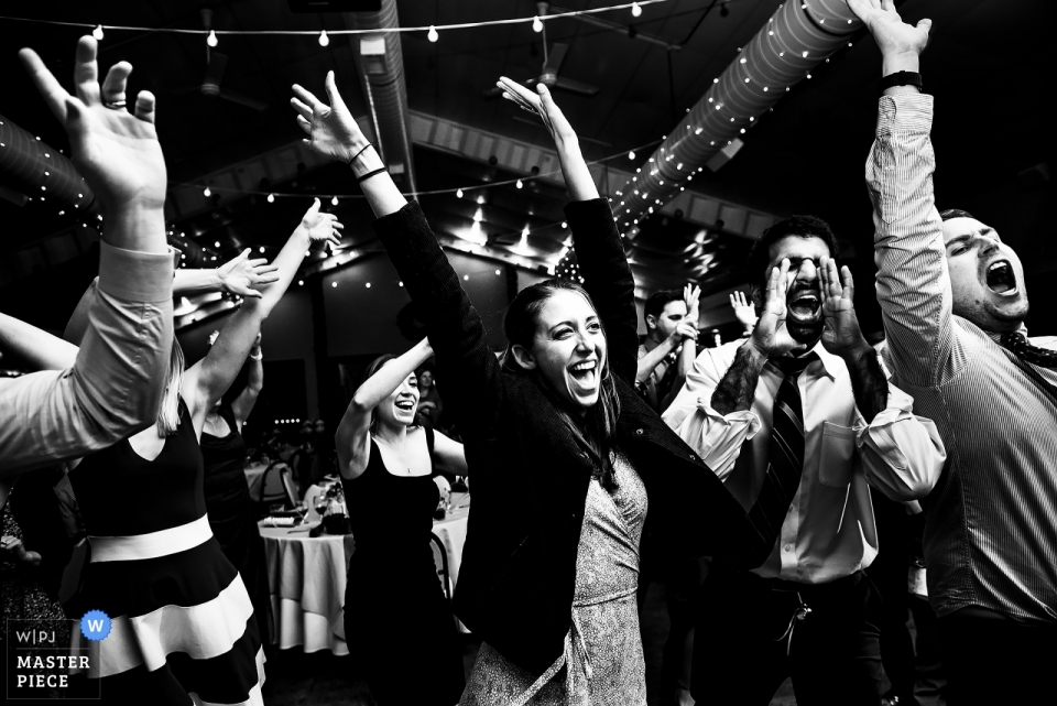 Photo by: <a href="https://www.wpja.com/contests/2018-v13/best-wedding-photographers/2288536">Jesse La Plante - Boulder Colorado</a> Shupe Homestead CO wedding photograph of dancing party guests at the wedding reception.
