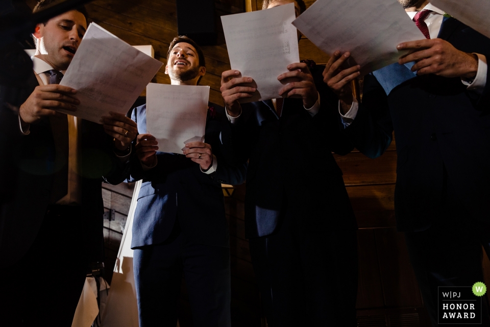 Documentary wedding photography at Migis Lodge, Maine - An a capella group serenades the couple at their ceremony