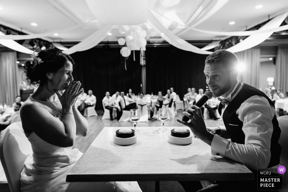 Photo by: <a href="https://www.wpja.com/contests/2018-v18/best-wedding-photographers/2361421">Jeremy Fiori - Angers </a> Pays de la Loire wedding photojournalism image of a couple - groom with mic at couple table