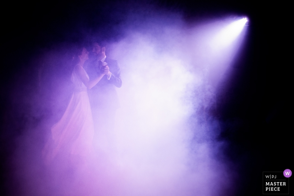Chateau de la Fresnay, Angers wedding photo with a couple dancing under purple lights Chateau de la Fresnay, Angers wedding photo with a couple dancing under purple lights
