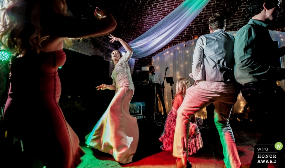 image of a Devon couple during their wedding with The bride on the dance floor at Polhawn Fort Devon couple during their wedding - The bride on the dance floor at Polhawn Fort
