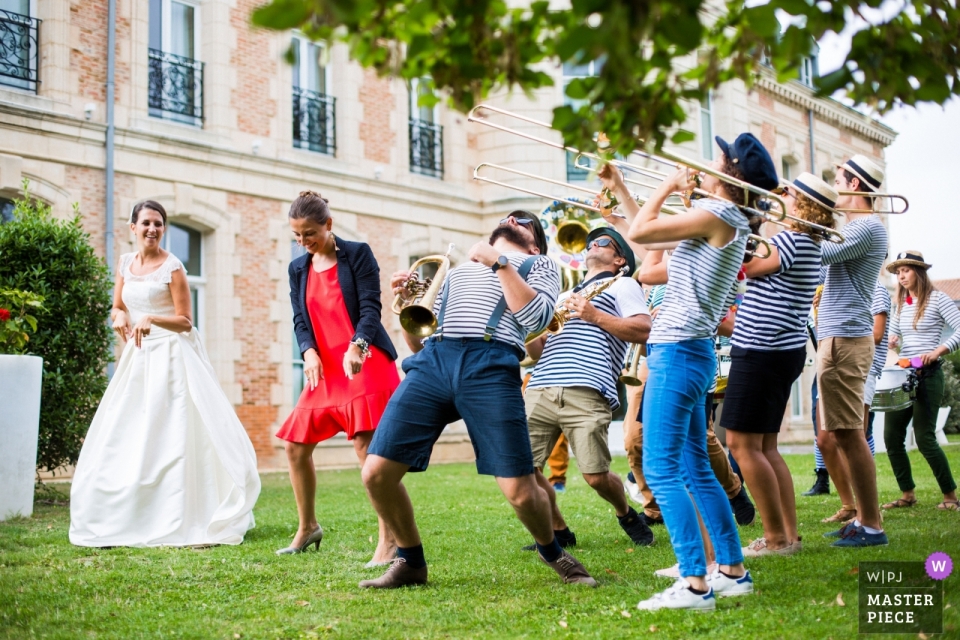 Photo by: <a href="https://www.wpja.com/contests/2018-v19/best-wedding-photographers/2373486">Florent Fauqueux - La Rochelle </a> Hotel SPA du Chateau LAGORD, France | A bride dances with marching band
