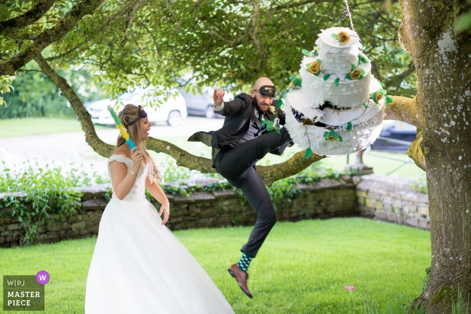 Wedding Photography of a Cake Pinata with the Bride and Groom at Brympton House in Somerset Brympton House in Somerset | Wedding Photography of a Cake Pinata with the Bride and Groom