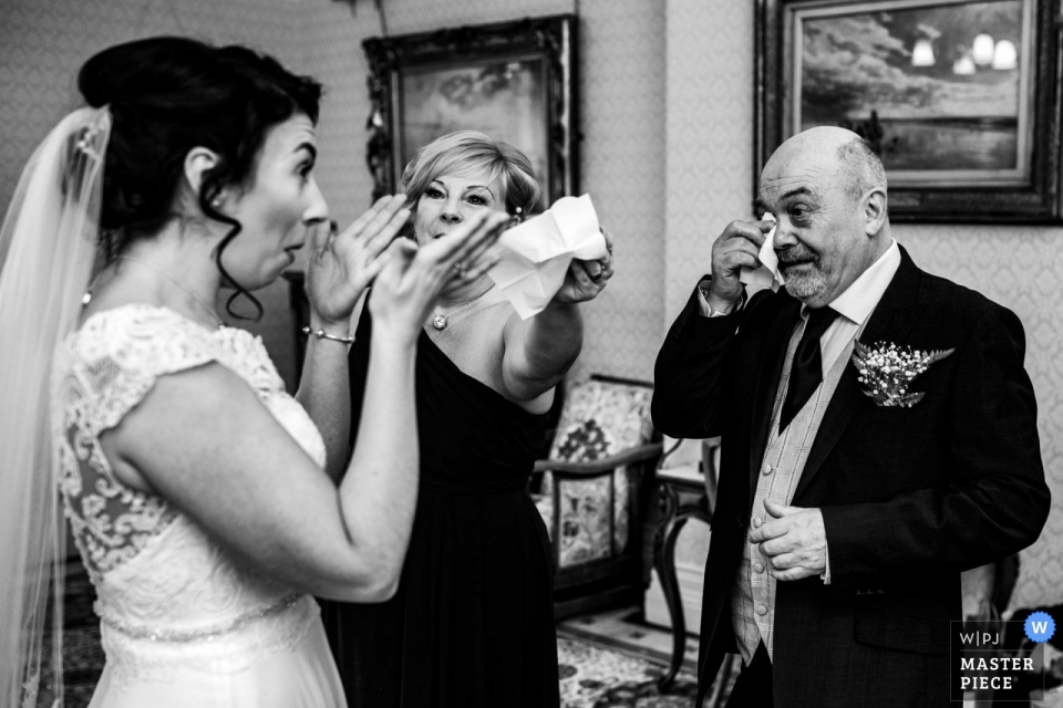 Photo by: <a href="https://www.wpja.com/contests/2019-v01/best-wedding-photographers/2433796">Darren Powell - Warwick Warwickshire</a> highbury hall wedding photograph of the dad ready to take his daughter to the church, but fighting back tears