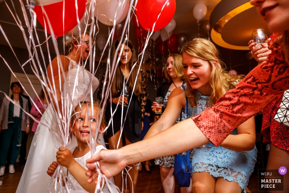 Wedding Photography of a Flower Girls Needing more balloons Hellendoorn- De Uitkijk Wedding Photography - Flower Girls Need more balloons!