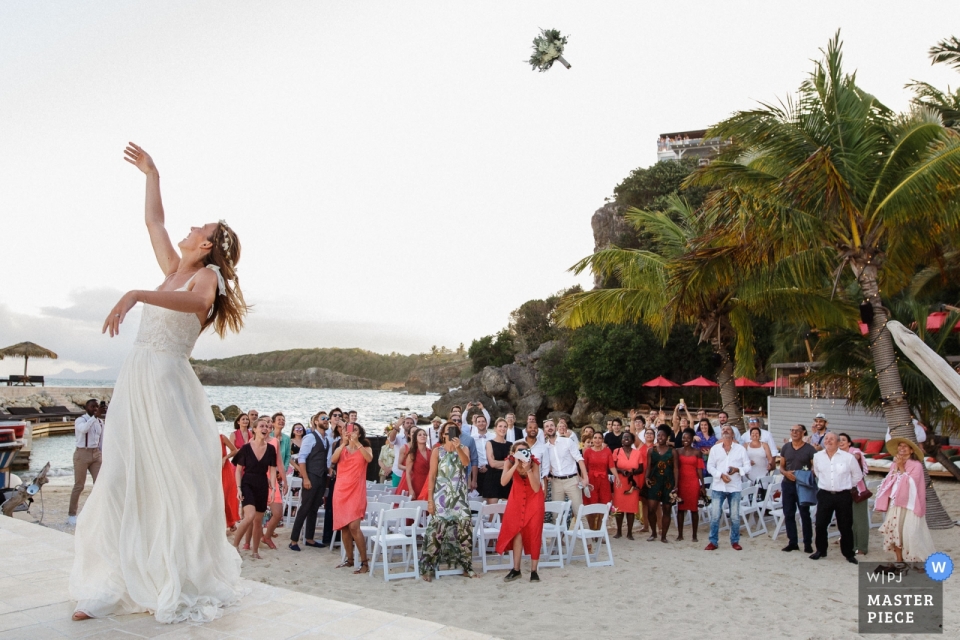 wedding day photograph of the Launched bouquet by the bride on the beach La Toubana - Guadeloupe wedding day photograph of the Launched bouquet by the bride on the beach
