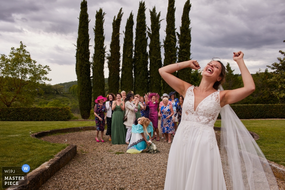 outdoor Villa La Selva Tuscany Wedding Photo During the Throwing of the Bouquet Villa La Selva Tuscany Wedding Photo During the Throwing of the Bouquet