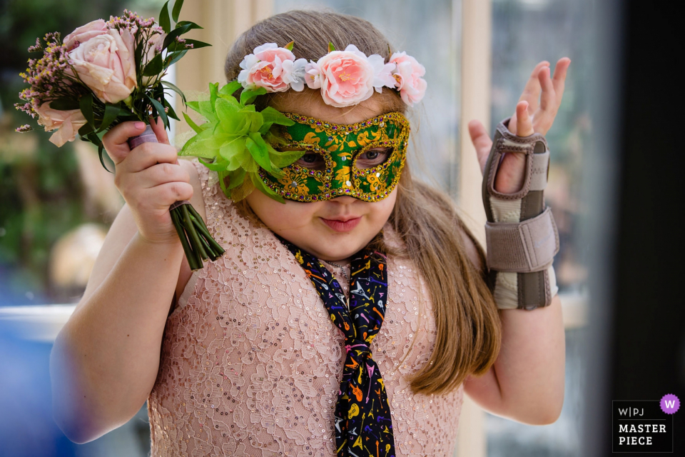 a Flower girl doing expressions and faces in the corner The Brownstone, Paterson, NJ wedding photographer: "Flower girl doing something in the corner. Thought it was adorable."