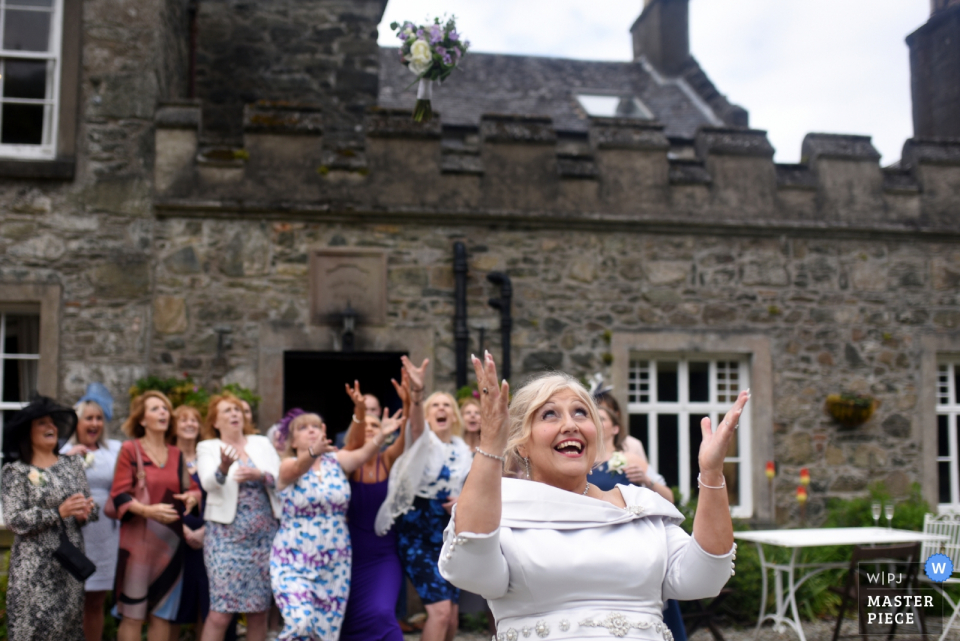 Lunga House Wedding Reception Photography Showing Bride Throwing the bouquet 