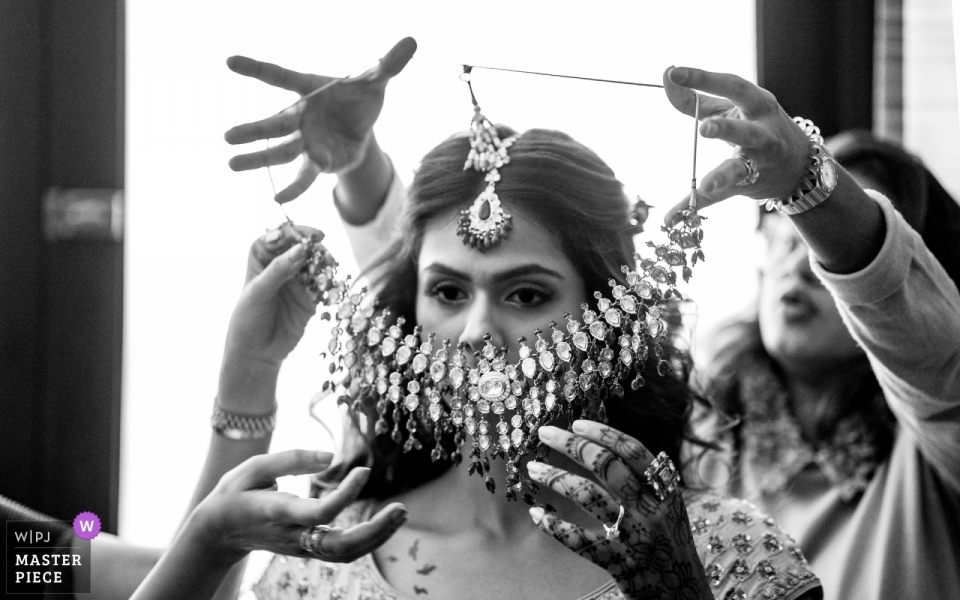 Bride getting ready with a lot of help Sofitel Hotel, Bahrain Wedding Day Photos of Bride getting ready with a lot of help.