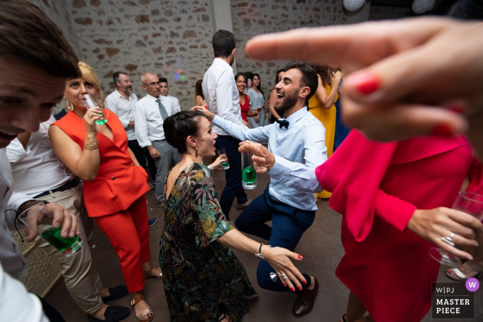 Photo by: <a href="https://www.wpja.com/contests/2019-v09/best-wedding-photographers/2542286">David Zaoui - Miami Florida</a> Domaine Malmont, Montpellier, France Wedding Photography - Evening party with a perspective between finger and this guest as if he wanted to go under the finger
